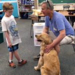 Student at Uwchlan Hills Elementary School playing with a dog